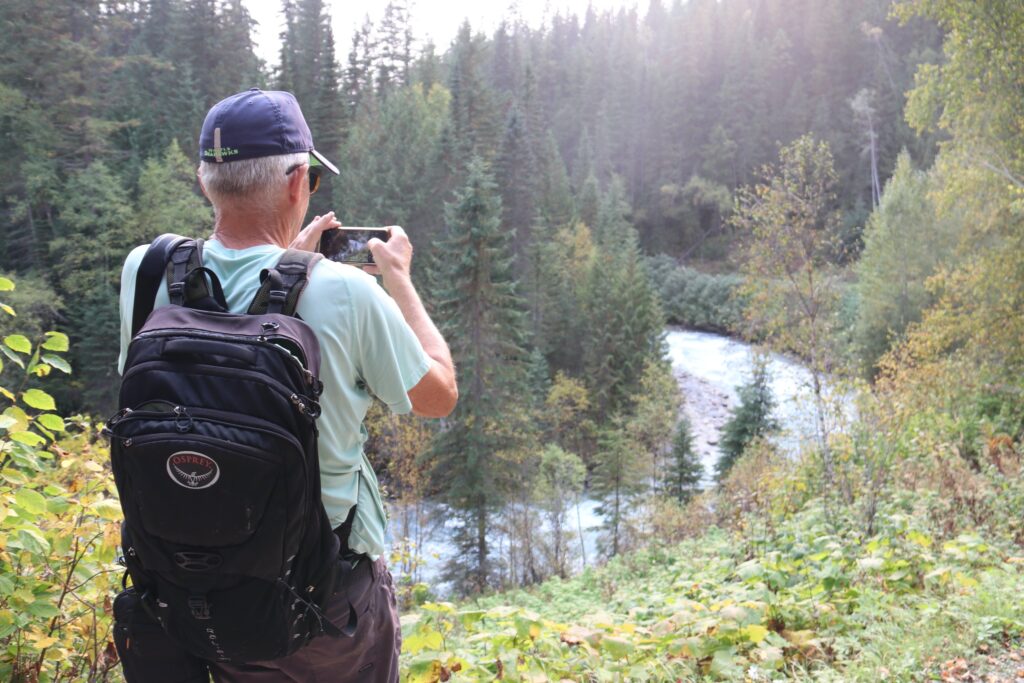 tennis tourist valemount bc mount robson bill taking picture of river